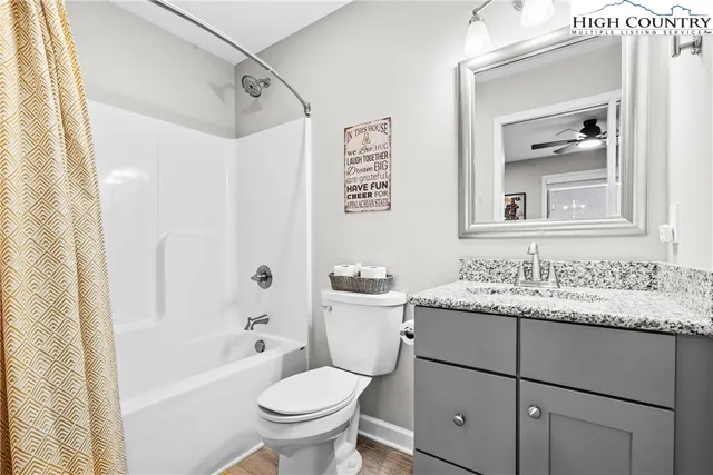 a bathroom with a sink toilet vanity and shower