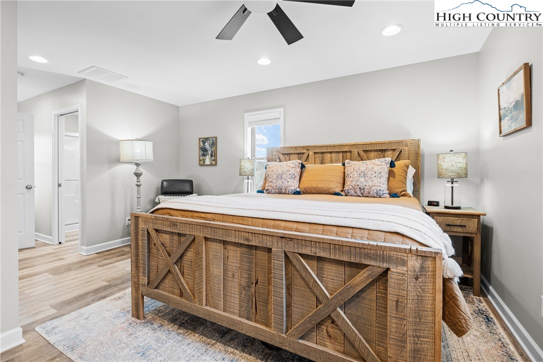 513 Townhomes Place, Unit 27 Boone, NC 28607 - Photo 21 of 33 a bedroom with a bed and a chandelier