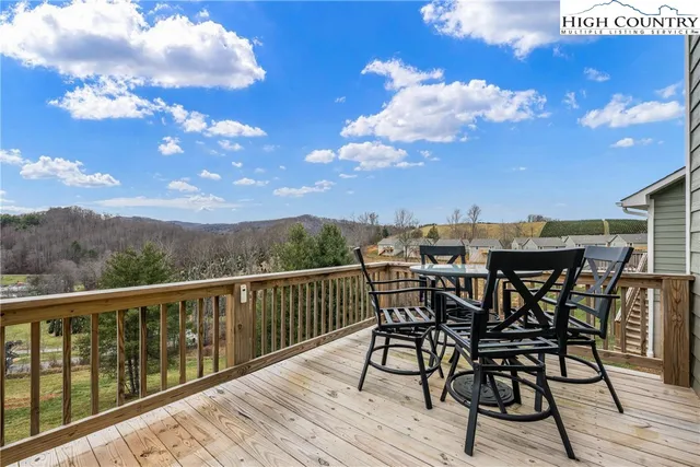 a view of a roof deck with table and chairs with wooden floor
