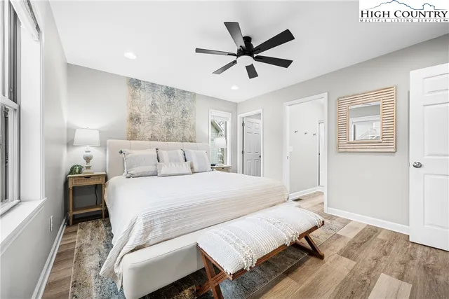 a bedroom with a bed and a chandelier