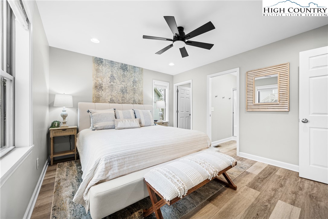 513 Townhomes Place, Unit 27 Boone, NC 28607 - Photo 5 of 33 a bedroom with a bed and a chandelier