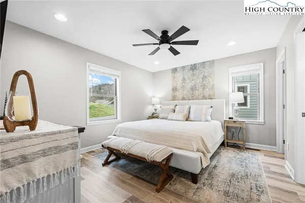 a bedroom with a large bed and a chandelier