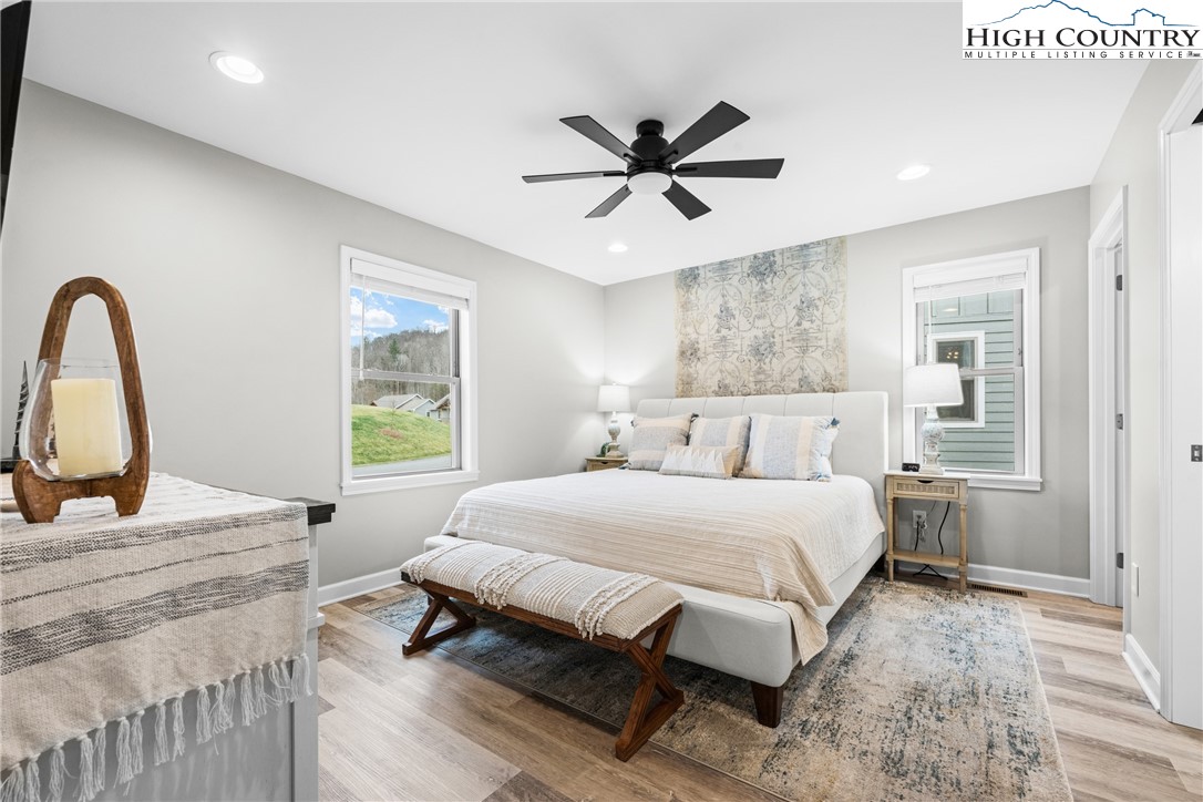 513 Townhomes Place, Unit 27 Boone, NC 28607 - Photo 6 of 33 a bedroom with a large bed and a chandelier