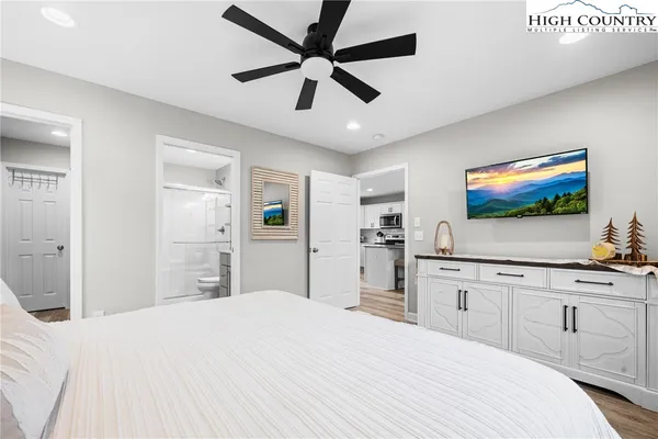 a bedroom with a bed and a flat screen tv