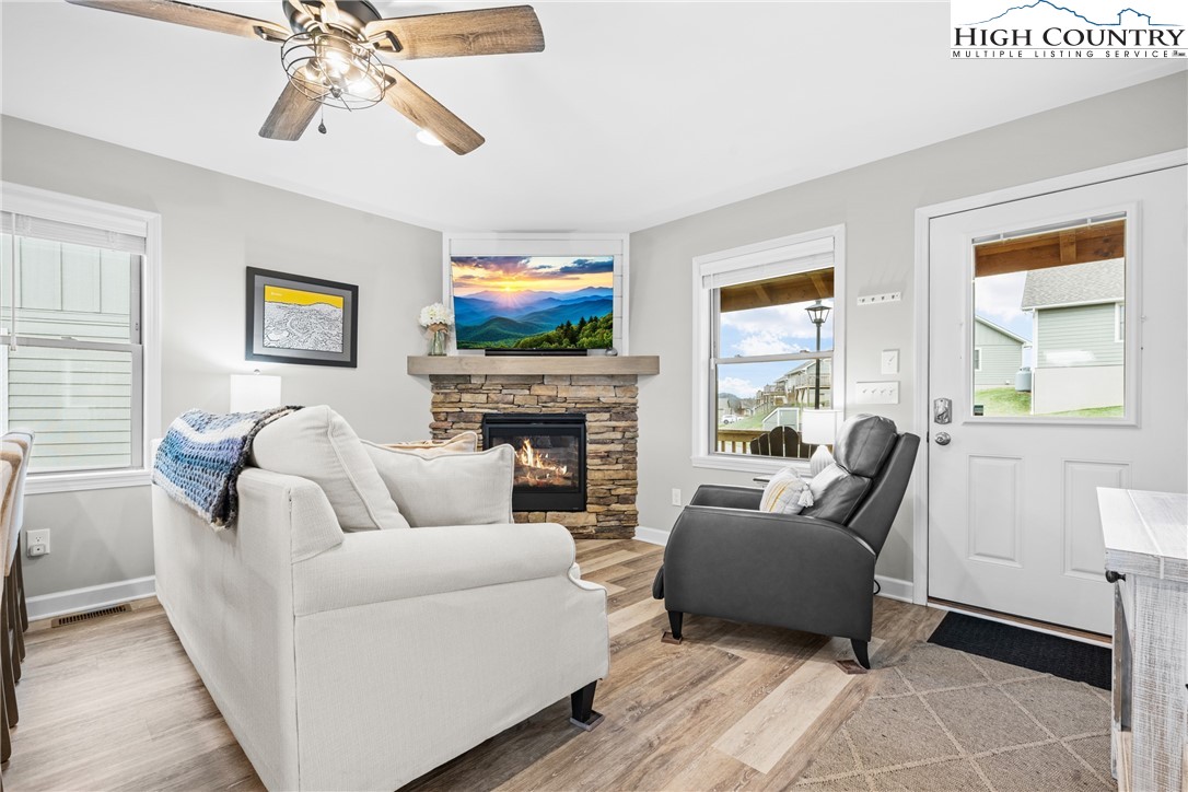 513 Townhomes Place, Unit 27 Boone, NC 28607 - Photo 9 of 33 a living room with furniture a flat screen tv and a fireplace