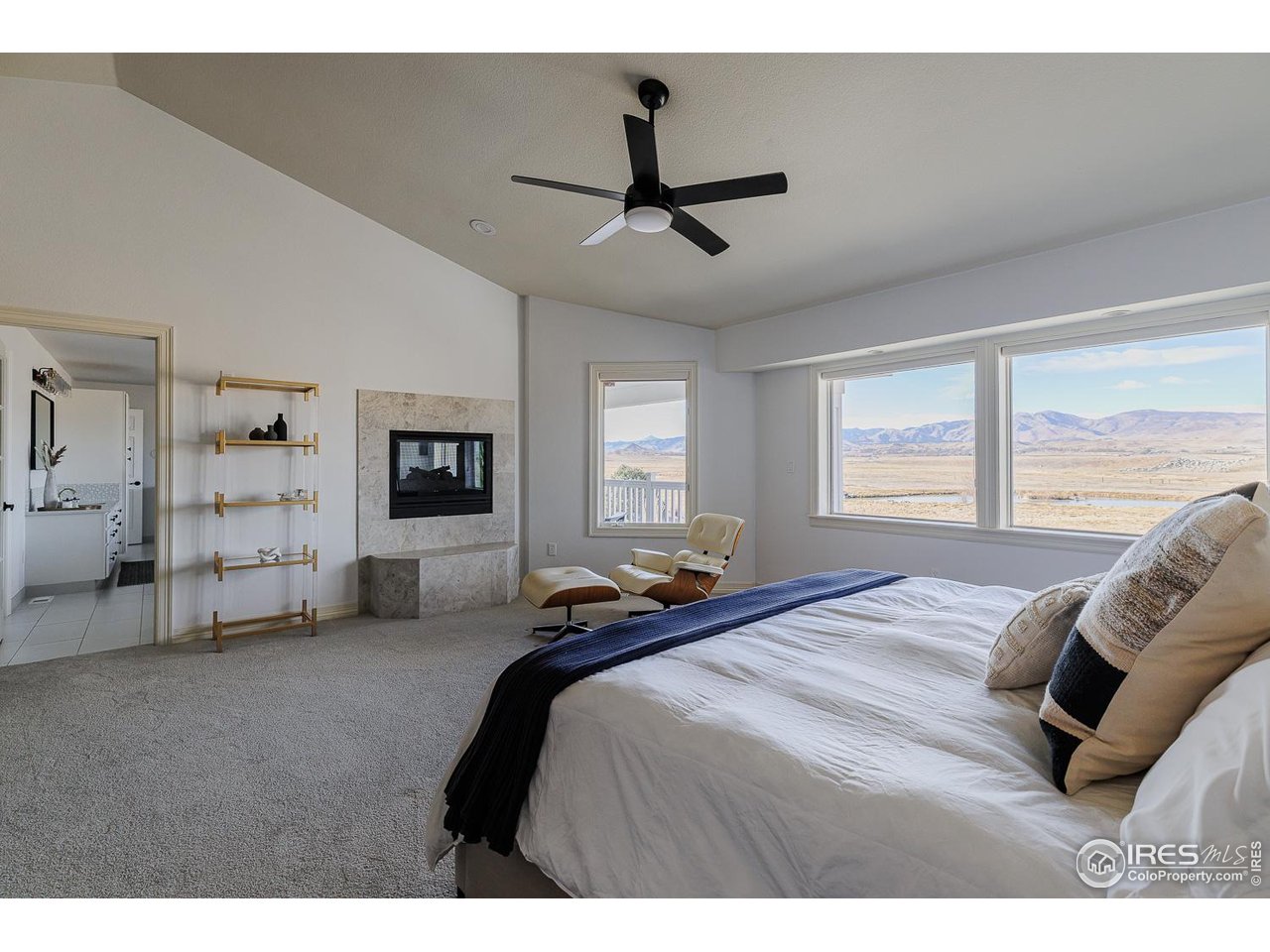 7401 Deerfield Road Longmont, CO 80503 - Photo 27 of 49 Primary suite with 2-sided gas fireplace