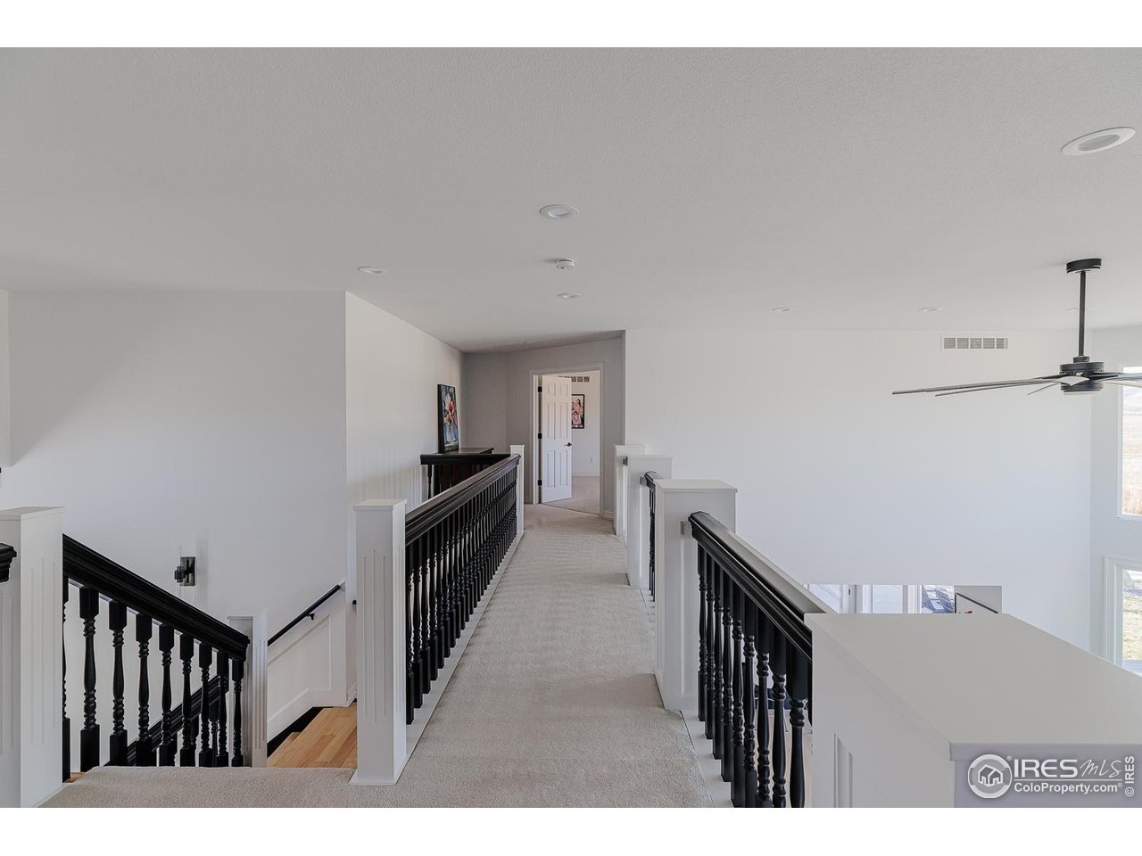 7401 Deerfield Road Longmont, CO 80503 - Photo 31 of 49 Upper Walkway between bedrooms