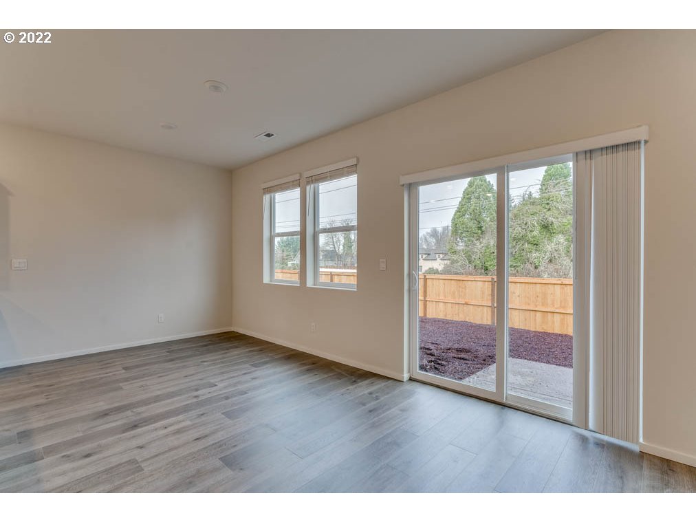 2674 26th Loop Springfield, OR 97477 - Photo 23 of 23 a view of an empty room with wooden floor and a window