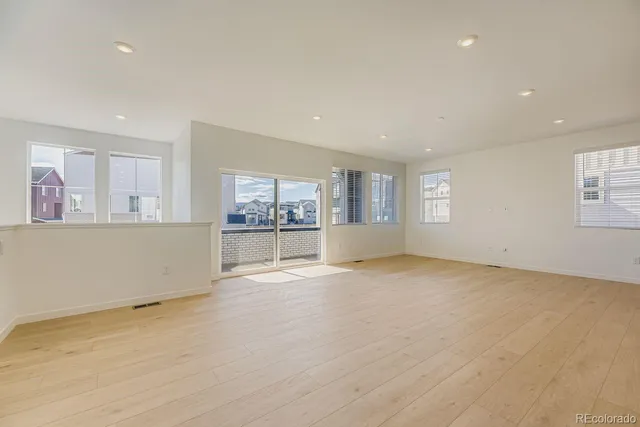 a view of an empty room and a window