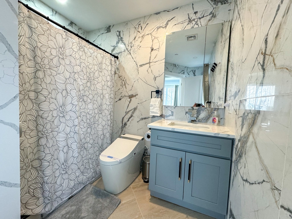 31 Train Street, Unit 3FURNISHED Boston, MA 02122 - Photo 11 of 17 a bathroom with a granite countertop sink toilet and shower