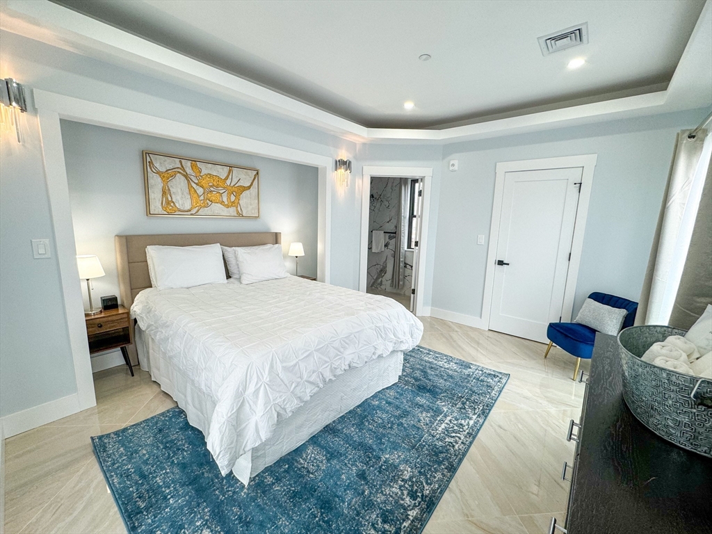 31 Train Street, Unit 3FURNISHED Boston, MA 02122 - Photo 12 of 17 a bedroom with a bed and wooden floor