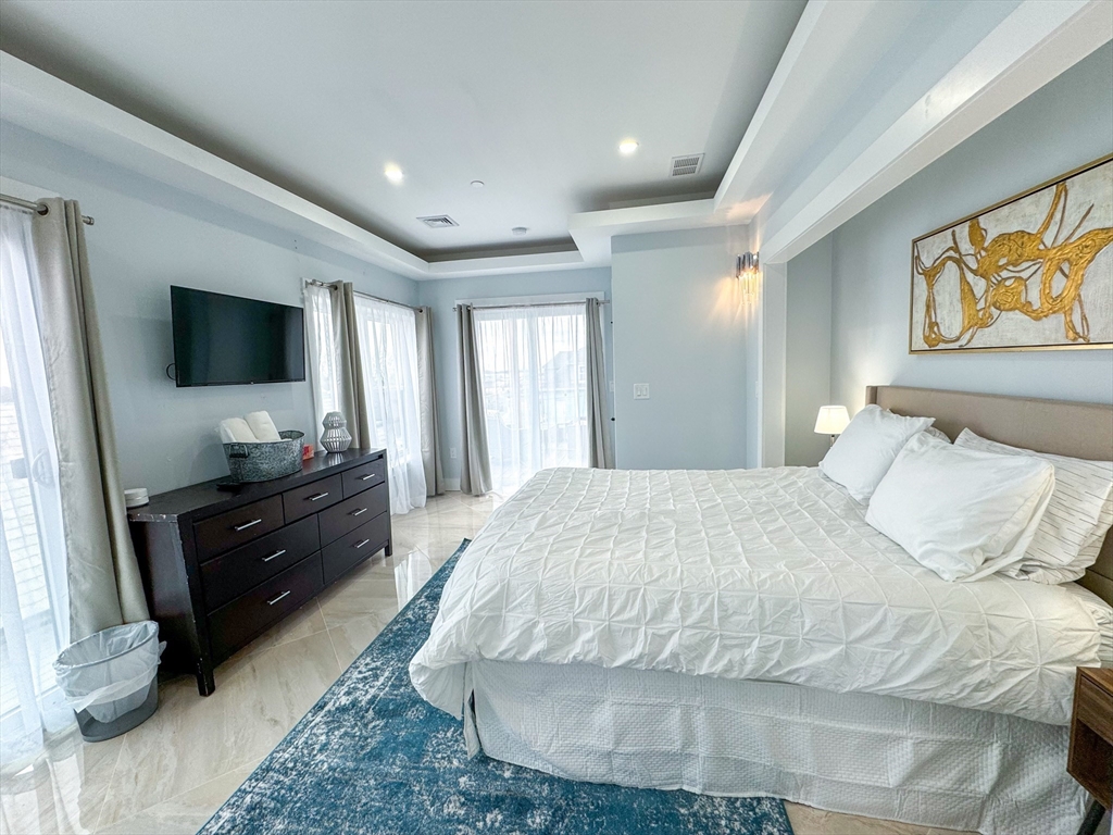 31 Train Street, Unit 3FURNISHED Boston, MA 02122 - Photo 13 of 17 a bedroom with a bed and a flat screen tv