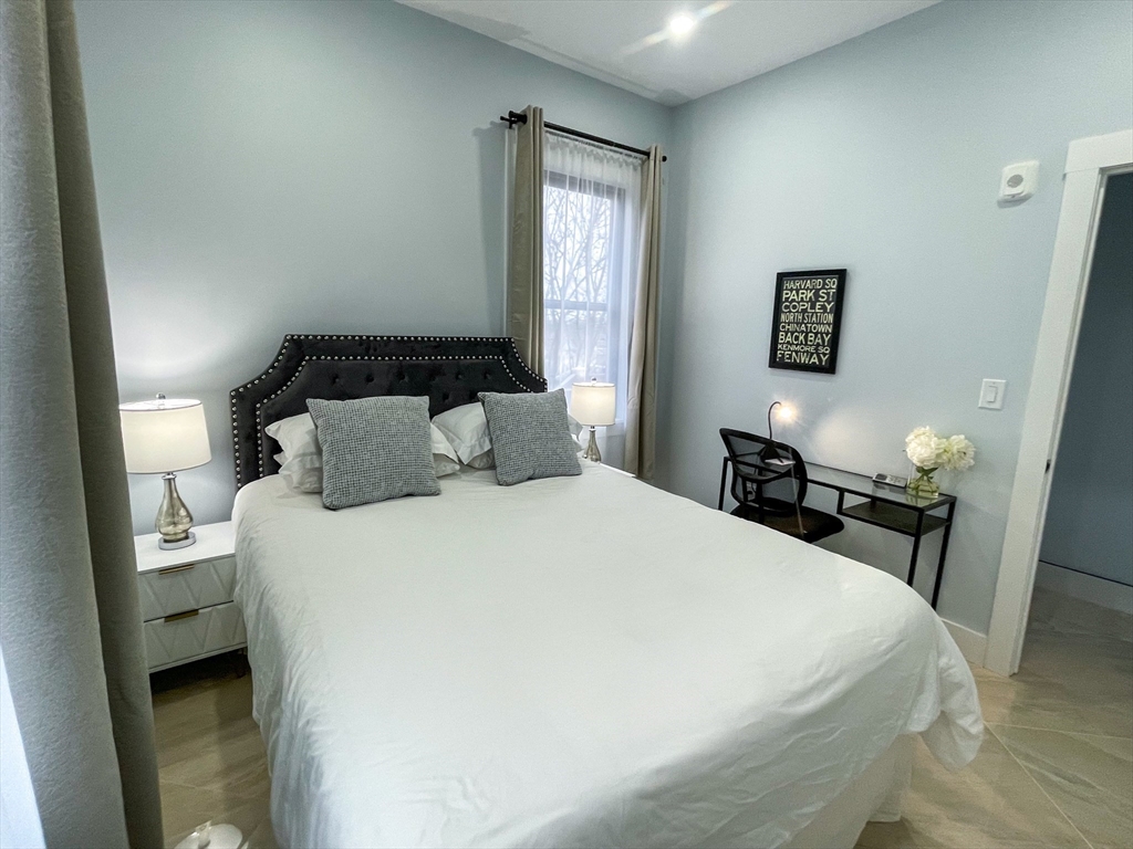 31 Train Street, Unit 3FURNISHED Boston, MA 02122 - Photo 16 of 17 a bedroom with a bed and wooden floor