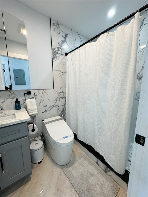 31 Train Street, Unit 3FURNISHED Boston, MA 02122 - Photo 17 of 17 a bathroom with a toilet sink and shower curtain