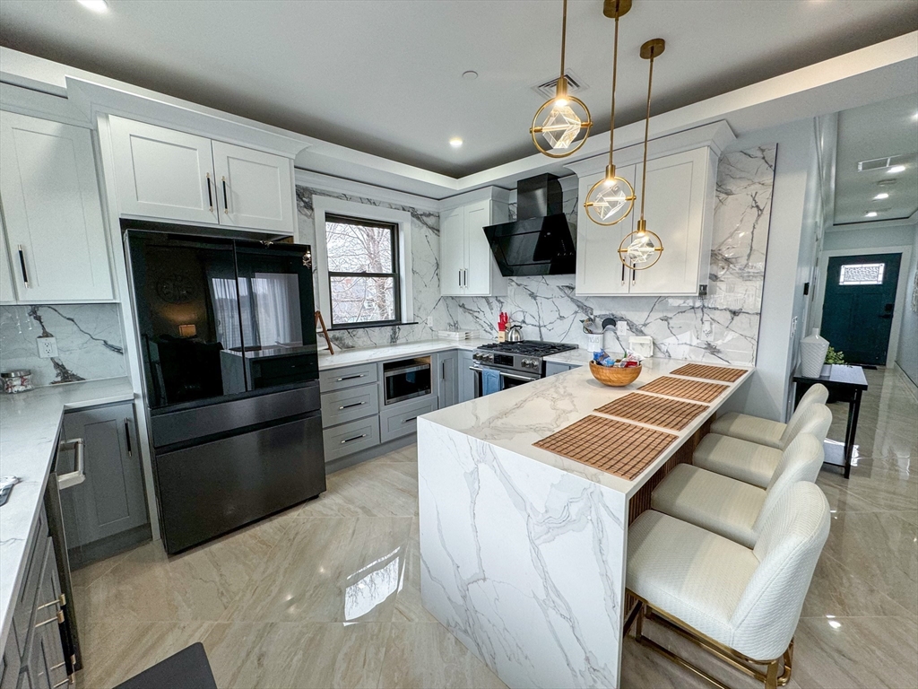31 Train Street, Unit 3FURNISHED Boston, MA 02122 - Photo 4 of 17 a kitchen with granite countertop a sink appliances and cabinets