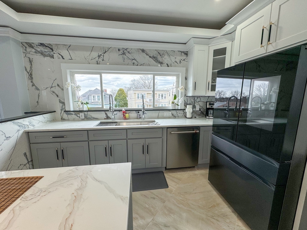 31 Train Street, Unit 3FURNISHED Boston, MA 02122 - Photo 7 of 17 a kitchen with a sink stove and cabinets