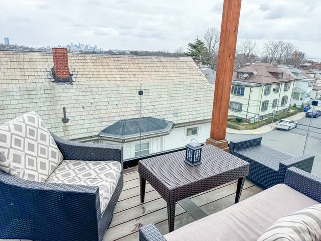 a balcony with table and chairs