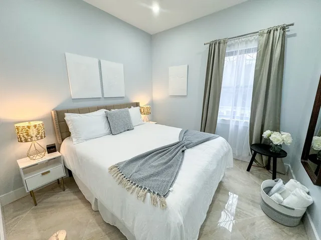 a bedroom with a bed and a chair