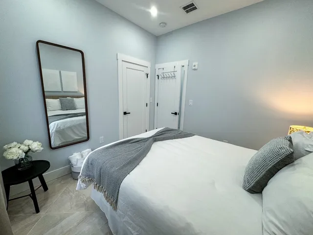 a bedroom with a bed and a mirror