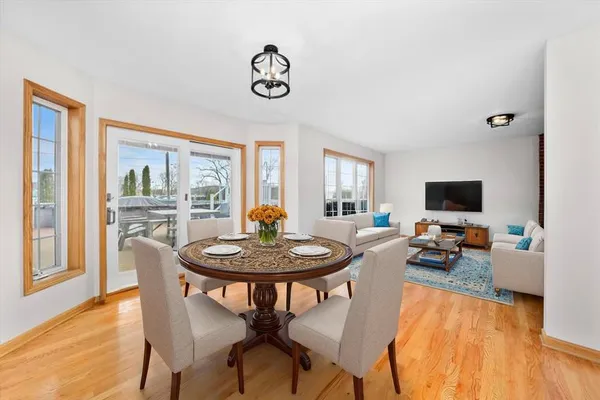 a kitchen with stainless steel appliances granite countertop a stove top oven a sink dishwasher and a microwave with wooden floor