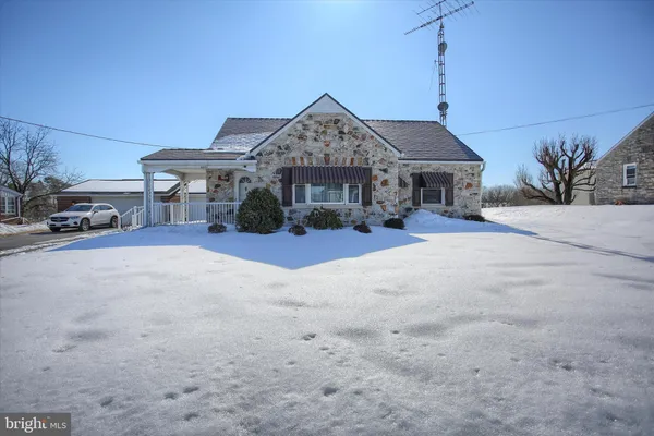 a view of a house with a large space in front of it