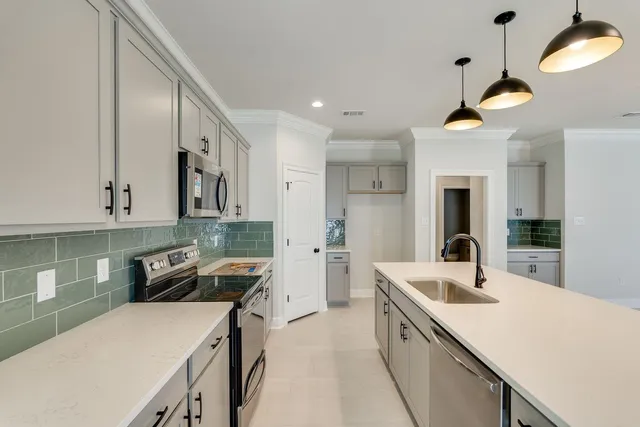 a kitchen with a sink a stove cabinets and refrigerator