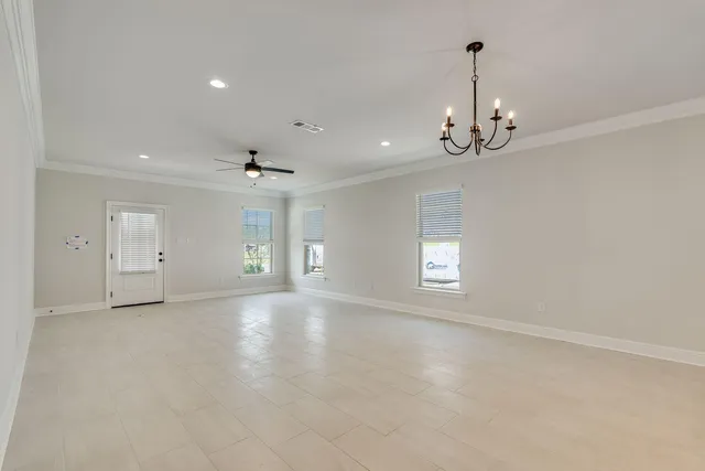 a view of a kitchen with a sink dishwasher a refrigerator and white cabinets