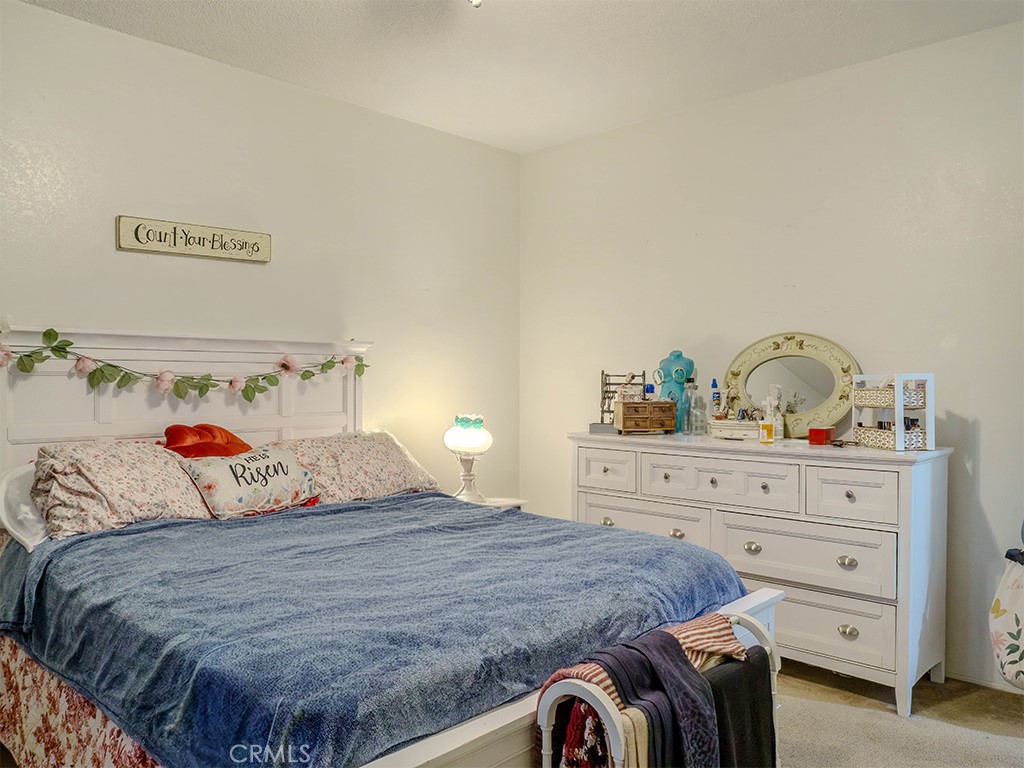9413 Garfield Street Riverside, CA 92503 - Photo 12 of 33 a bedroom with a bed and a dresser