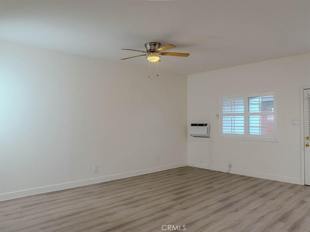 9413 Garfield Street Riverside, CA 92503 - Photo 12 of 19 a view of empty room with wooden floor and fan