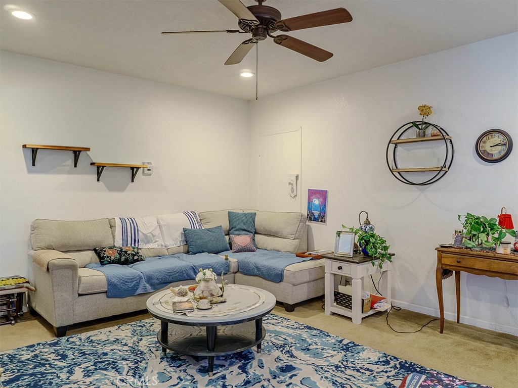 9413 Garfield Street Riverside, CA 92503 - Photo 15 of 33 a living room with furniture a rug and a wall painting
