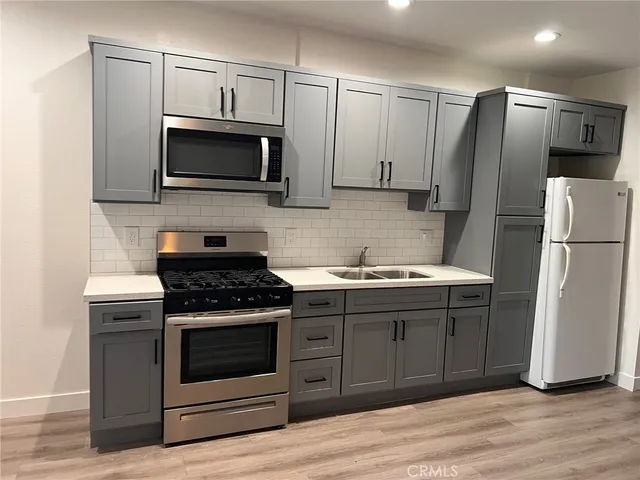 a kitchen with a sink stove and microwave