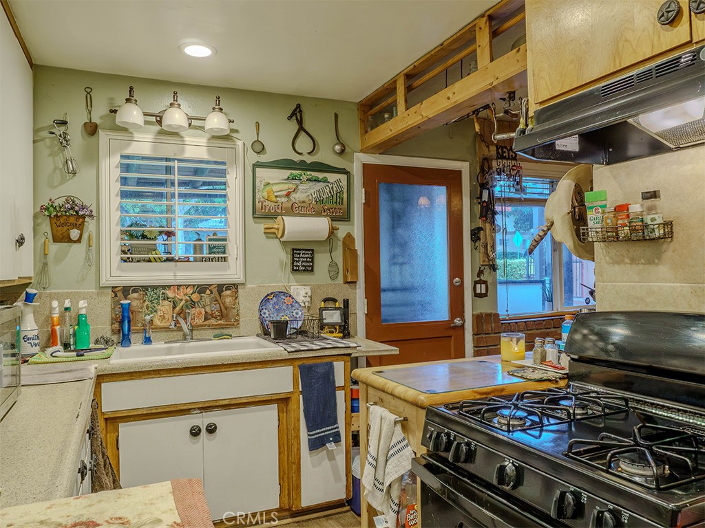 9413 Garfield Street Riverside, CA 92503 - Photo 26 of 33 a kitchen with a stove and a sink
