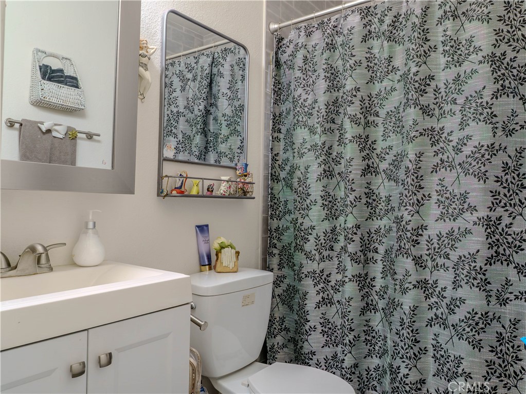 9413 Garfield Street Riverside, CA 92503 - Photo 9 of 33 a bathroom with a toilet sink and mirror