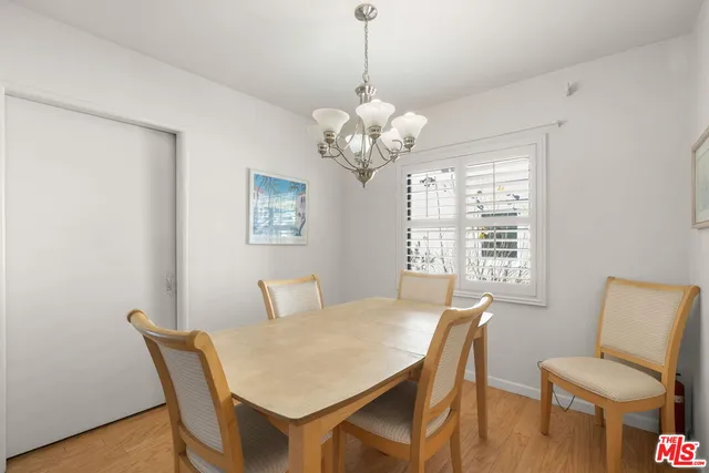 a kitchen with white cabinets and sink