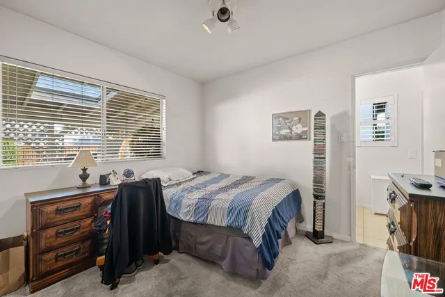 a bedroom with furniture and a flat screen tv