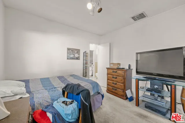 a bedroom with a bed and a couch