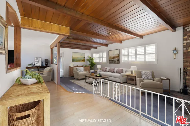 a living room with lots of furniture and a chandelier