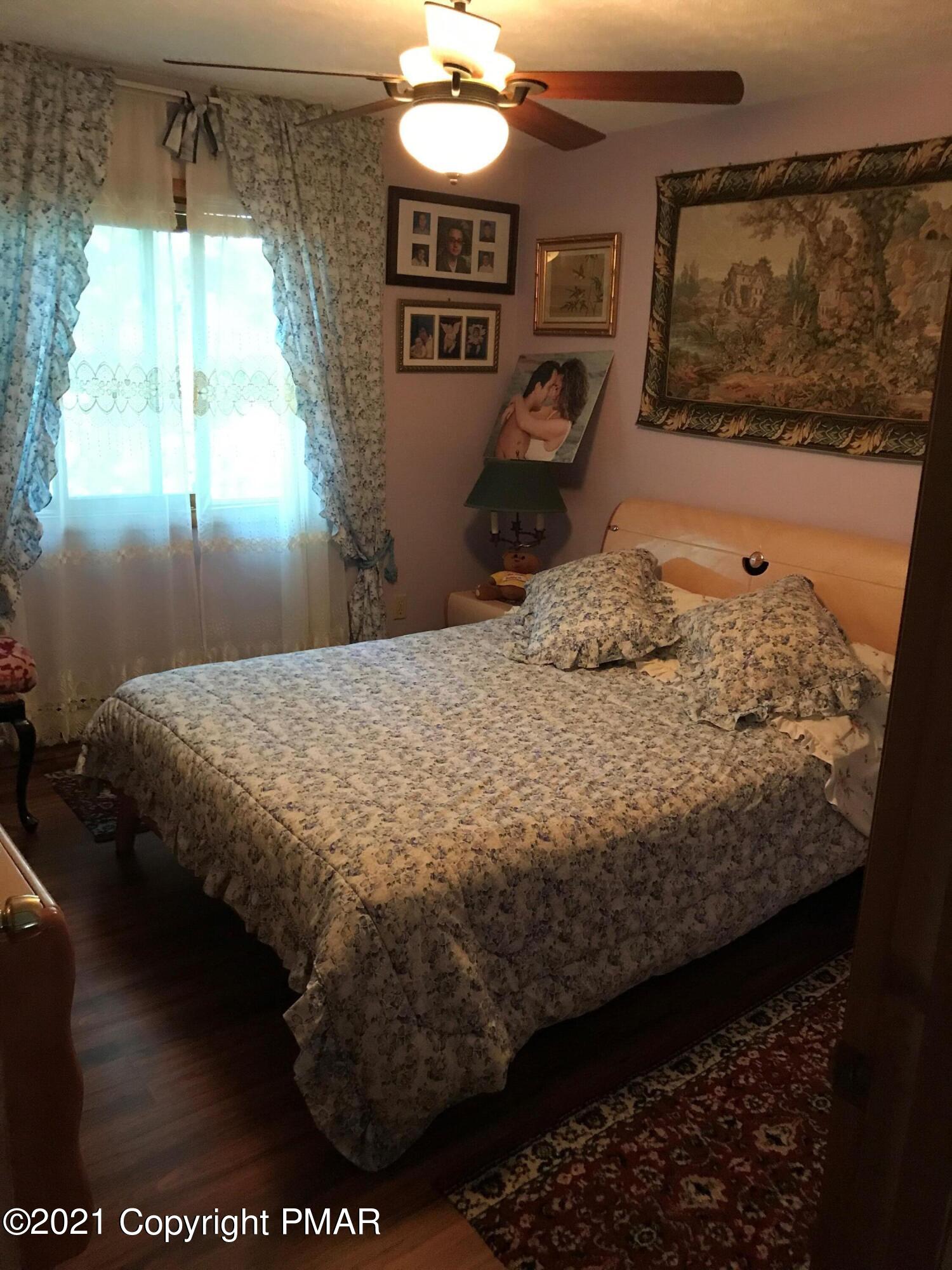 716 Dundee Road Bushkill, PA 18324 - Photo 21 of 38 a bedroom with a bed and window