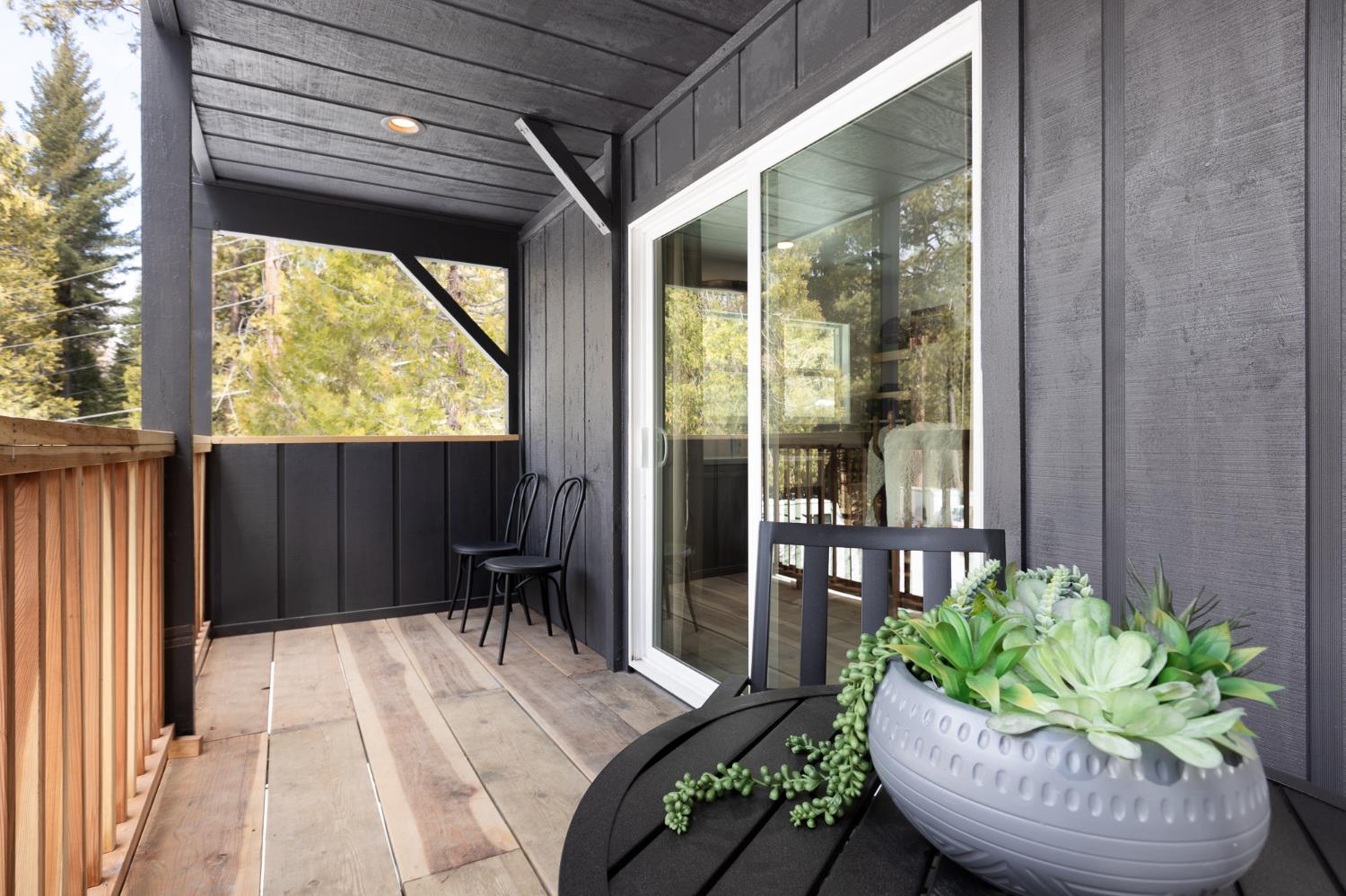 42145 Tollhouse Road Shaver Lake, CA 93664 - Photo 14 of 22 a view of a porch with furniture and floor to ceiling window