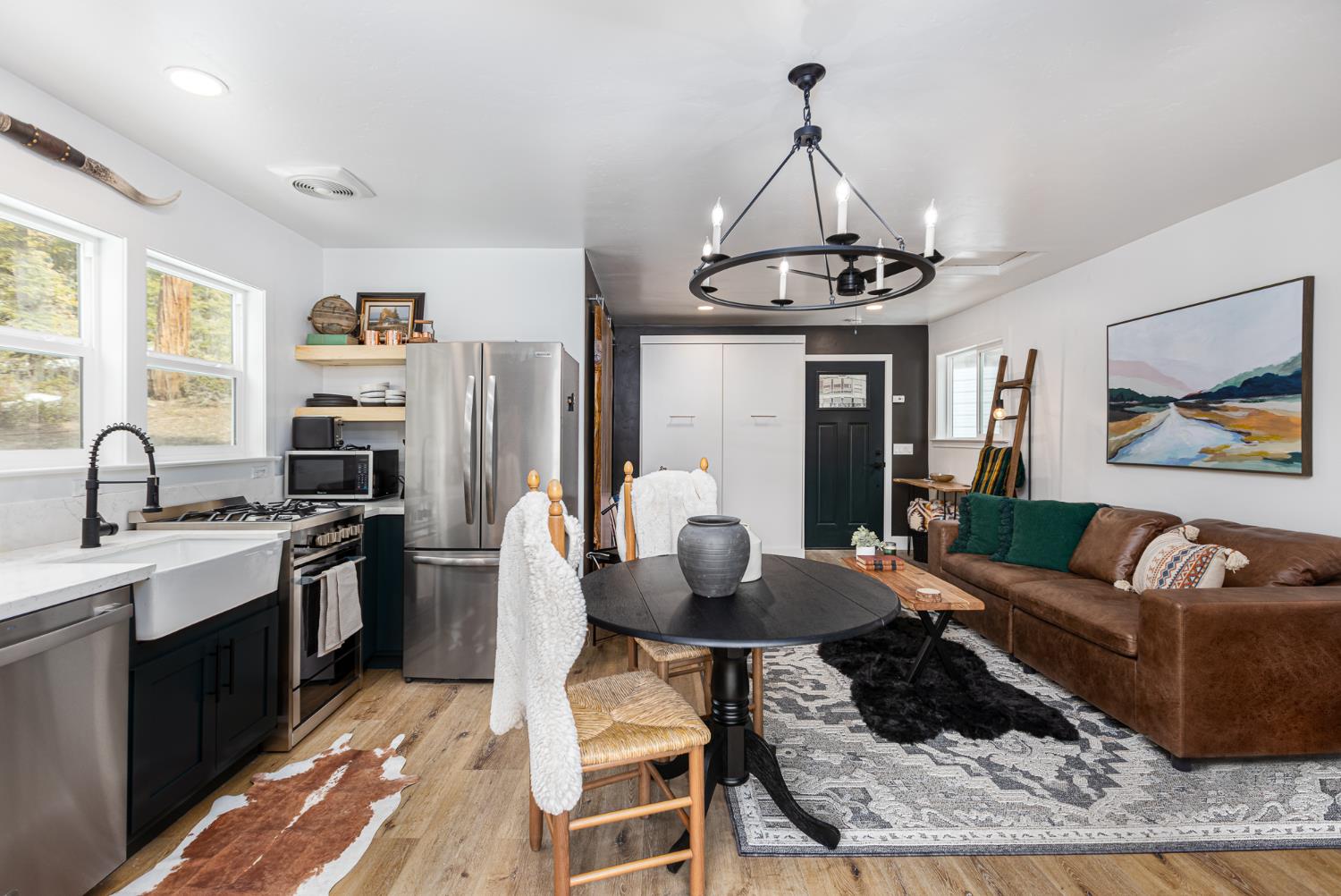 42145 Tollhouse Road Shaver Lake, CA 93664 - Photo 15 of 22 a living room with stainless steel appliances granite countertop furniture a rug a fireplace and a window