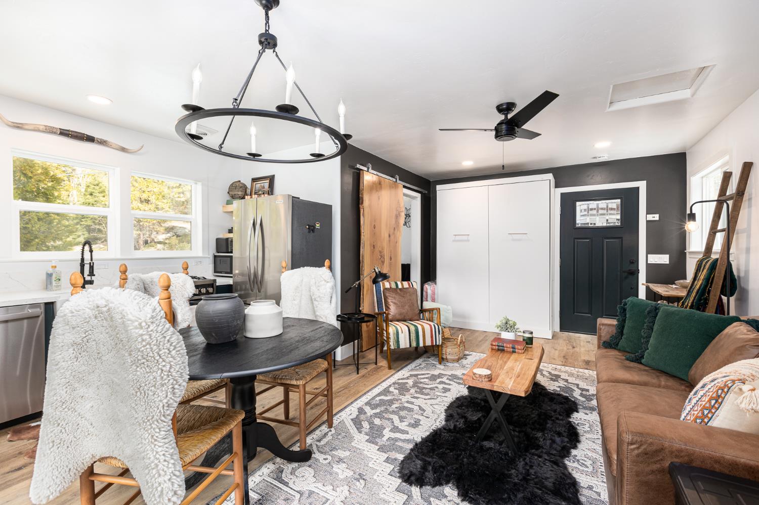 42145 Tollhouse Road Shaver Lake, CA 93664 - Photo 9 of 22 a living room with furniture a window and a chandelier