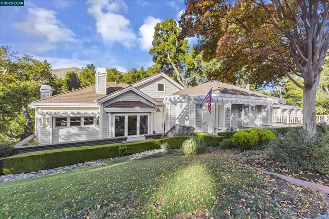 a front view of a house with a garden