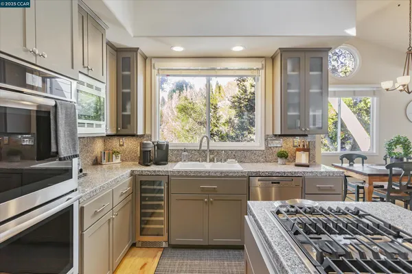 a kitchen with a sink stove and cabinets
