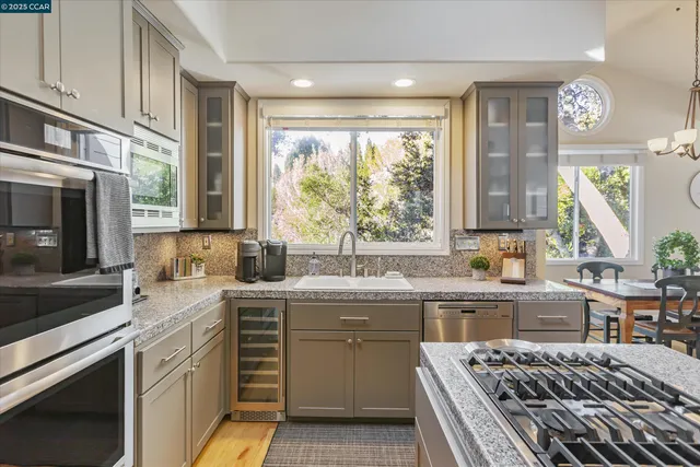 a kitchen with a sink stove and cabinets