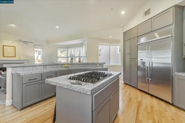 a kitchen that has a sink a stove and a refrigerator