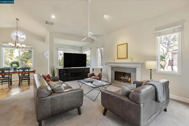 a living room with furniture a fireplace and a flat screen tv