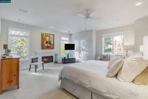 a spacious bedroom with a bed and a flat screen tv