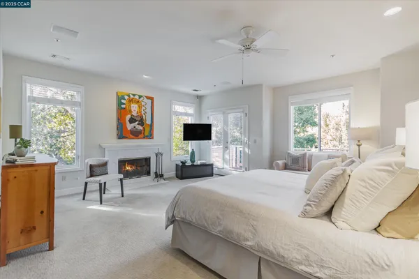 a spacious bedroom with a bed and a flat screen tv