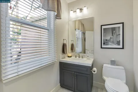 a bathroom with a toilet a sink and mirror