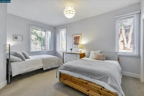 a bedroom with two beds and a couch